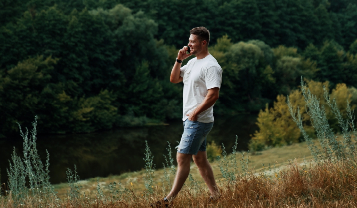 Man walking down hill on phone crossroads