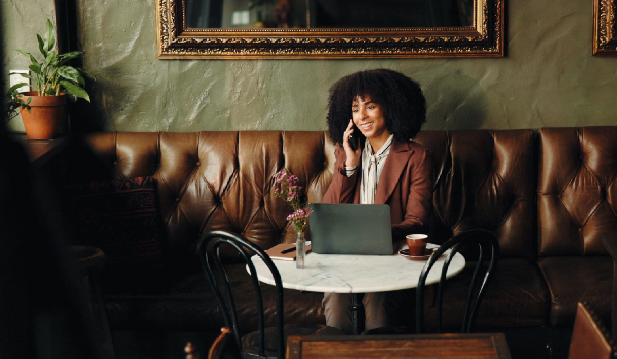 Woman sitting at a table on the phone