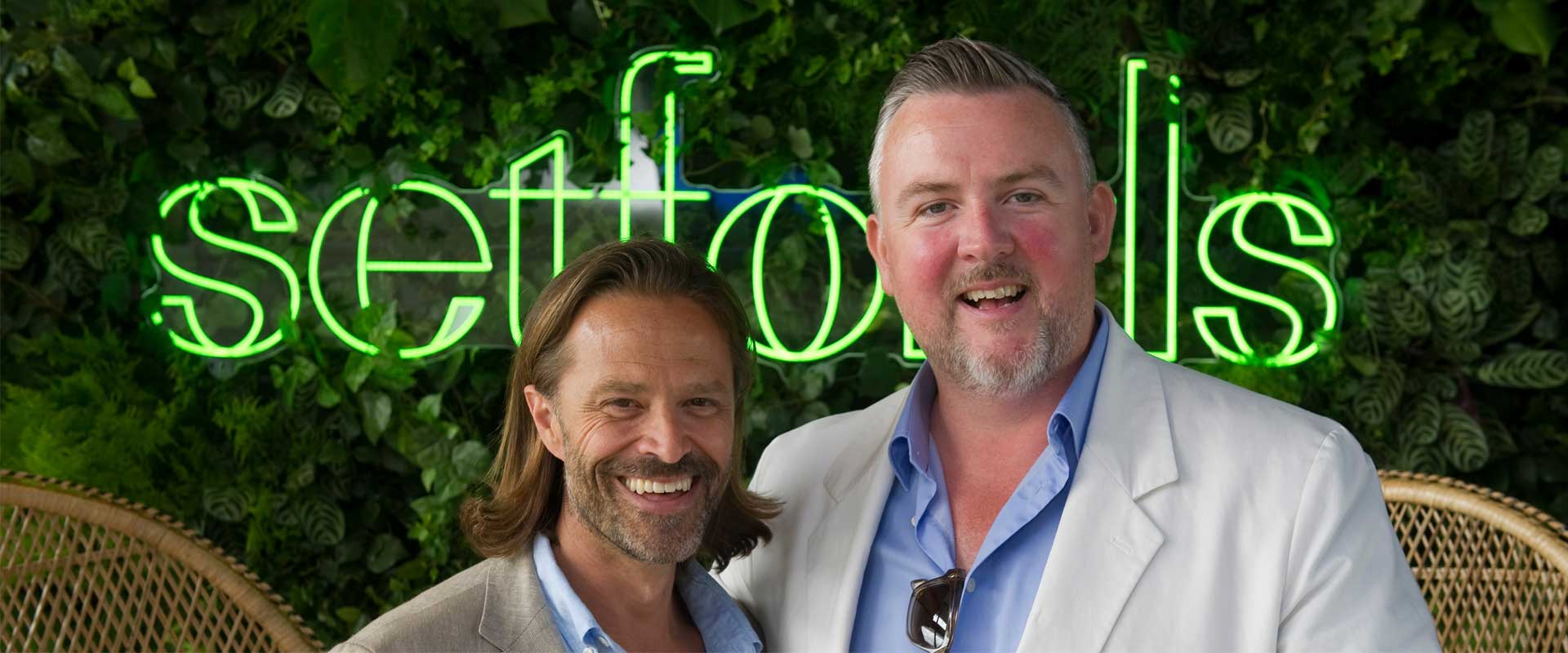 Chris and Guy Setford in front of the Setfords logo